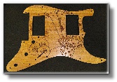 Several examples of truss rod covers that we've done out of exotic woods and plastics